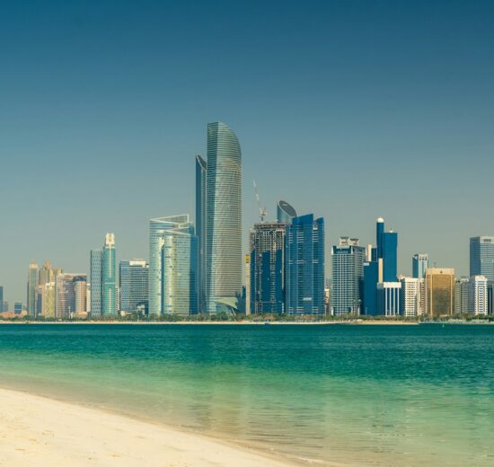 Abu Dhabi city skyline across the sea during the day