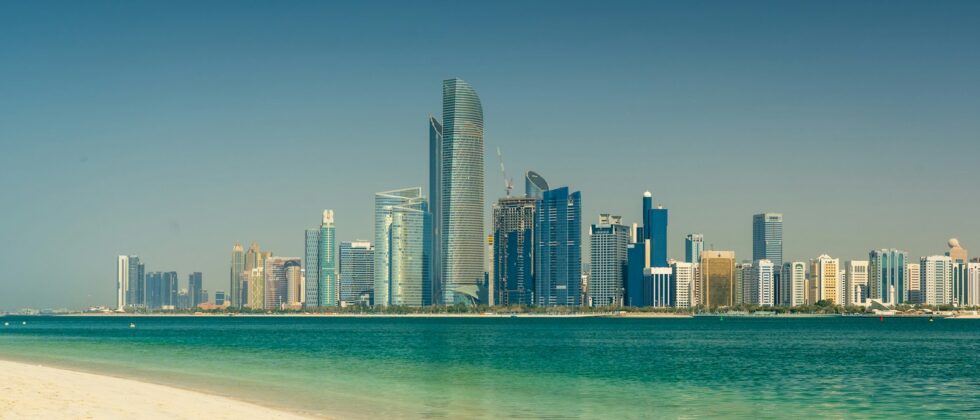 Abu Dhabi city skyline across the sea during the day