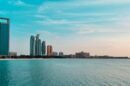 Abu Dhabi city skyline across a body of water during the day