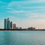 Abu Dhabi city skyline across a body of water during the day