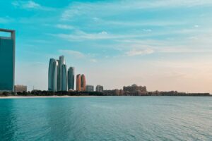 Abu Dhabi city skyline across a body of water during the day