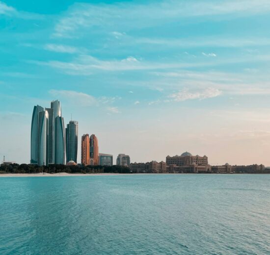 Abu Dhabi city skyline across a body of water during the day