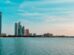 Abu Dhabi city skyline across a body of water during the day