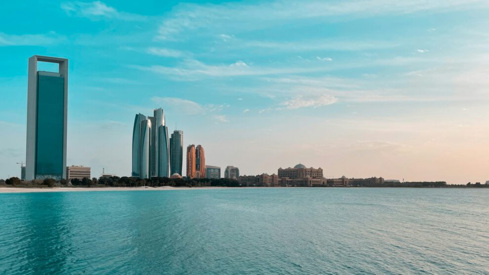 Abu Dhabi city skyline across a body of water during the day