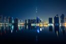 Dubai skyline with Burj Khalifa reflected in the water at night