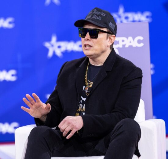 Elon Musk speaking on stage as neocloud stocks fall