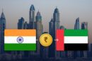 Indian and UAE flags with a rupee coin over the Dubai Marina skyline