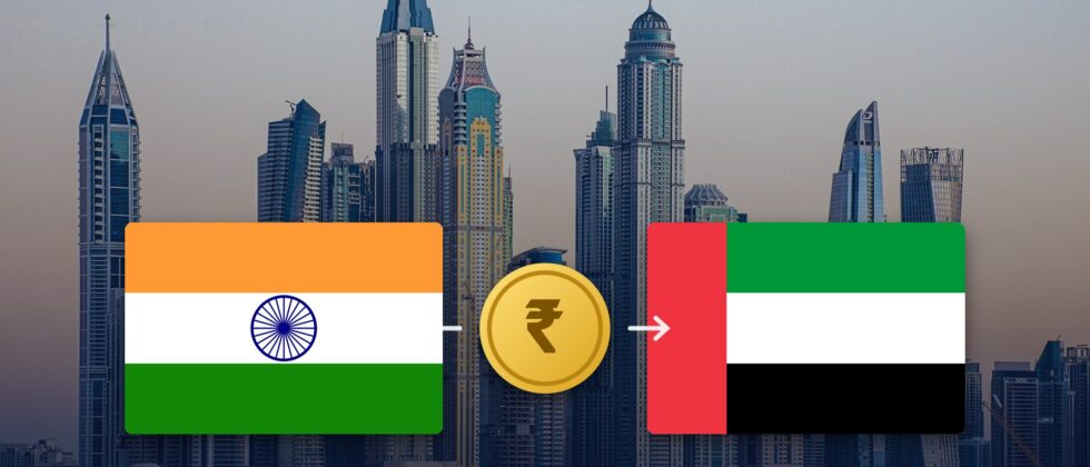 Indian and UAE flags with a rupee coin over the Dubai Marina skyline