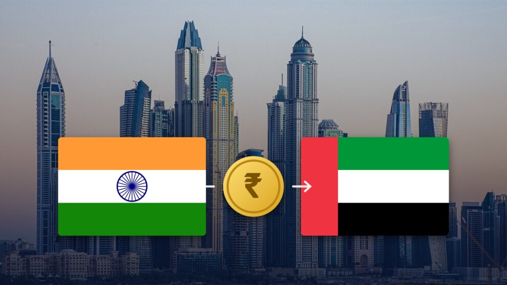 Indian and UAE flags with a rupee coin over the Dubai Marina skyline