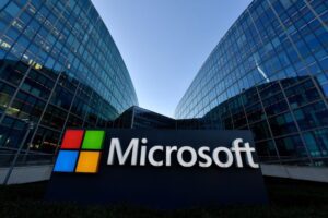 Microsoft sign in front of glass office buildings