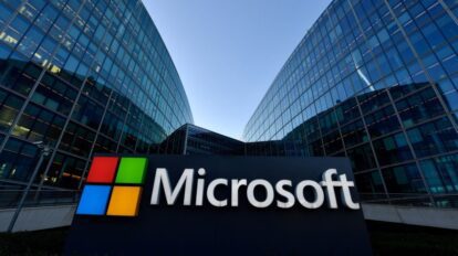 Microsoft sign in front of glass office buildings