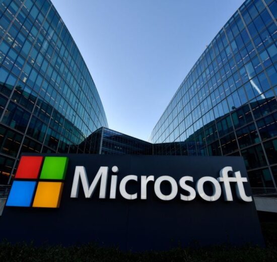 Microsoft sign in front of glass office buildings