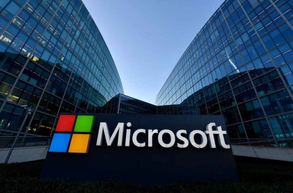 Microsoft sign in front of glass office buildings